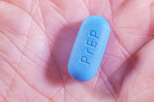 A closeup shot of a PrEP pill in a person's palm.