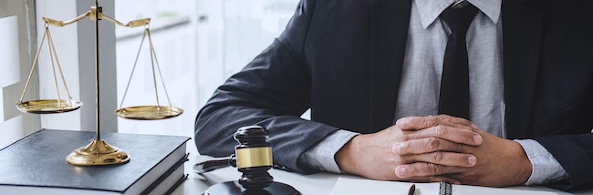 Understanding the Mass Tort Legal Process Explained A male lawyer is working with contract papers, Law books, and a wooden gavel on a table in an office.