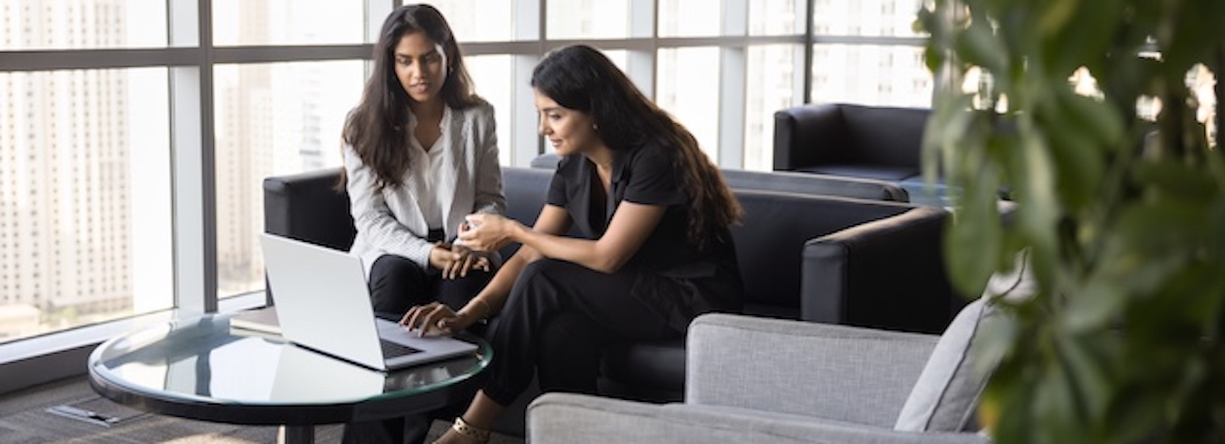 Understanding the Mass Tort Legal Process Explained Two women discuss ideas/strategies shown on a laptop, analyzing data and brainstorming creative solutions.