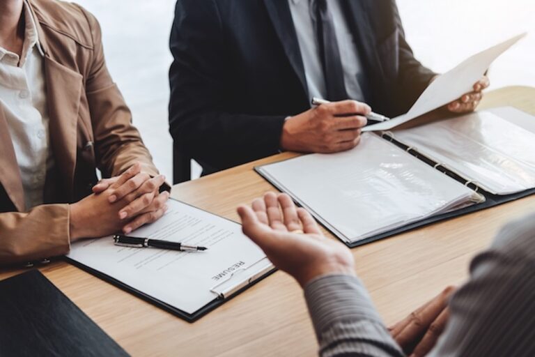 A male lawyer is deep in conversation with two other people.