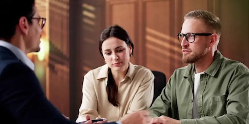 Understanding Defective Product Liability in Mass Tort Cases Caucasian male lawyer with glasses, consulting on defective product liability in mass tort case with Caucasian couple.