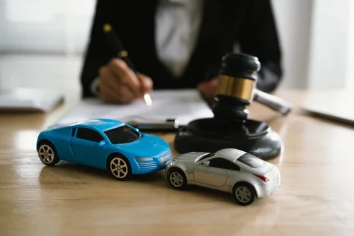 San Diego car accident lawyer at desk with miniature cars