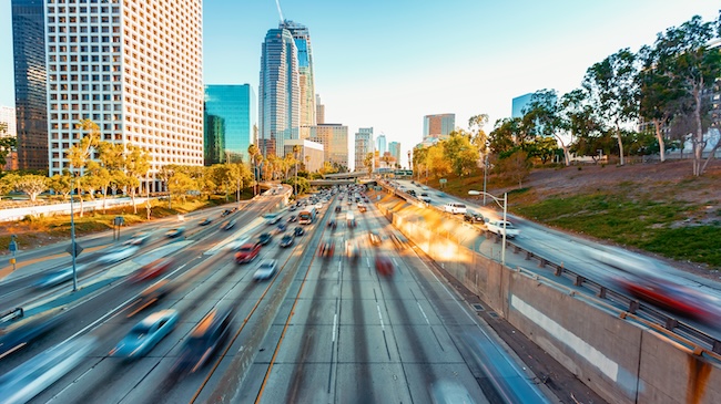 View of San Diego city skyline with busy highways and traffic, representing local car accident risk areas.