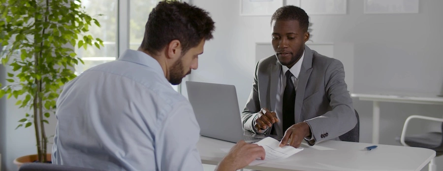 An attorney is speaking with a client about filing a Cartiva implant lawsuit in Boston.